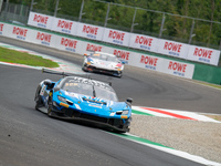 Nicolo Rosi, Niccolo Schiro, and David Fumanelli of team Kessel Racing stand next to a Ferrari 296 GT3 GT car on a pit lane during the Fanat...