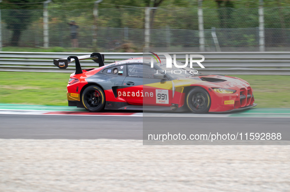 Christopher Haase, Alex Aka, and Ricardo Feller of Team Tresor Attempto Racing stand by an Audi R8 LMS GT3 EVO II GT car on a pit lane durin...