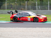 Christopher Haase, Alex Aka, and Ricardo Feller of Team Tresor Attempto Racing stand by an Audi R8 LMS GT3 EVO II GT car on a pit lane durin...