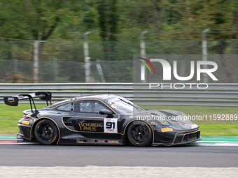 Ralf Bohn, Morris Schuring, and Robert Renauer of team Herberth Motorsport stand next to a Porsche 911 GT3 R (992) GT car on a pit lane duri...