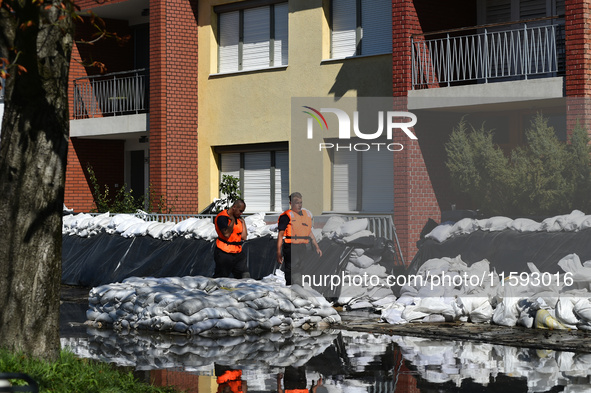 Firefighters patrol the flood barrier on the bank of the Danube in Vac, Hungary, about 42km from Budapest, as the peak water levels of the D...