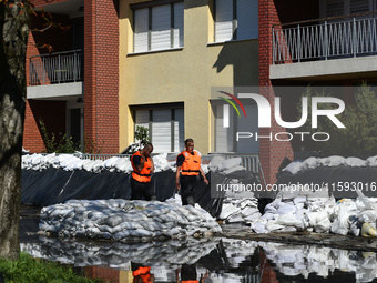 Firefighters patrol the flood barrier on the bank of the Danube in Vac, Hungary, about 42km from Budapest, as the peak water levels of the D...