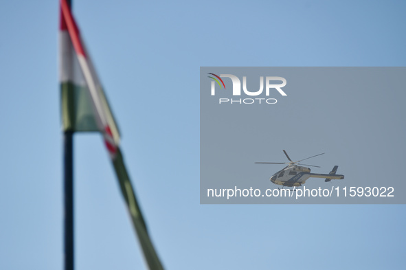 A police helicopter patrols the flood protection works on the bank of the Danube in Vac, Hungary, about 42km from Budapest, as the peak wate...