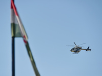 A police helicopter patrols the flood protection works on the bank of the Danube in Vac, Hungary, about 42km from Budapest, as the peak wate...