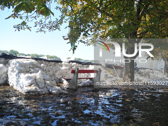 A bench sits near the flood protection works on the bank of the Danube in Vac, Hungary, about 42km from Budapest, as the peak water levels o...