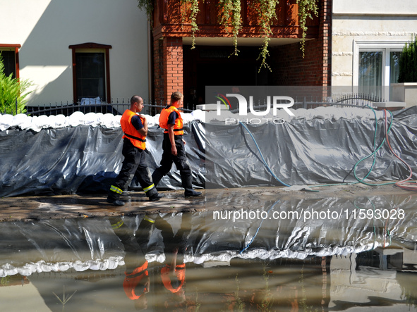 Firefighters patrol the flood protection works on the bank of the Danube in Vac, Hungary, about 42km from Budapest, as the peak water levels...