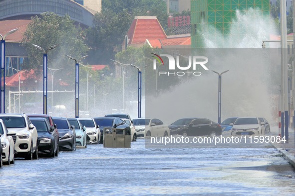 Big waves hit vehicles on Binhai North Road in Yantai, Shandong province, China, on September 21, 2024. 