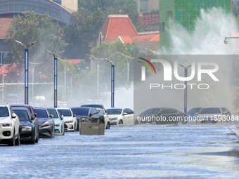 Big waves hit vehicles on Binhai North Road in Yantai, Shandong province, China, on September 21, 2024. (