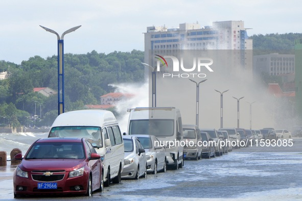 Big waves hit vehicles on Binhai North Road in Yantai, Shandong province, China, on September 21, 2024. 