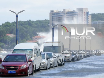 Big waves hit vehicles on Binhai North Road in Yantai, Shandong province, China, on September 21, 2024. (