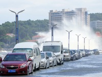 Big waves hit vehicles on Binhai North Road in Yantai, Shandong province, China, on September 21, 2024. (