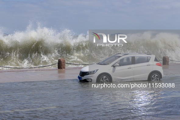 Big waves hit vehicles on Binhai North Road in Yantai, Shandong province, China, on September 21, 2024. 