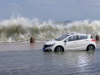 Big waves hit vehicles on Binhai North Road in Yantai, Shandong province, China, on September 21, 2024. (