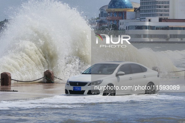 Big waves hit vehicles on Binhai North Road in Yantai, Shandong province, China, on September 21, 2024. 