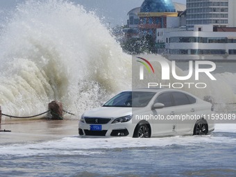 Big waves hit vehicles on Binhai North Road in Yantai, Shandong province, China, on September 21, 2024. (