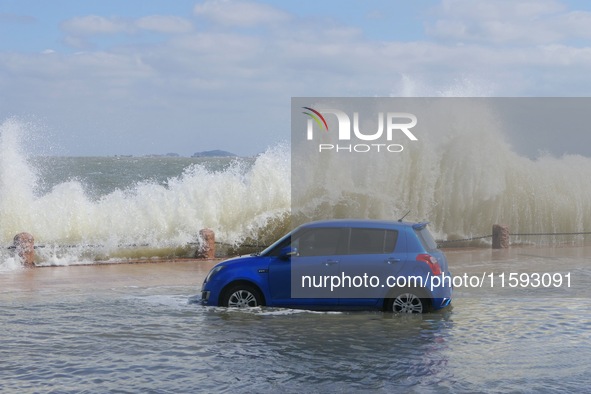 Big waves hit vehicles on Binhai North Road in Yantai, Shandong province, China, on September 21, 2024. 