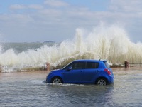 Big waves hit vehicles on Binhai North Road in Yantai, Shandong province, China, on September 21, 2024. (