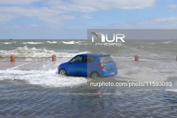 Big waves hit vehicles on Binhai North Road in Yantai, Shandong province, China, on September 21, 2024. 