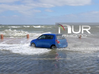 Big waves hit vehicles on Binhai North Road in Yantai, Shandong province, China, on September 21, 2024. (