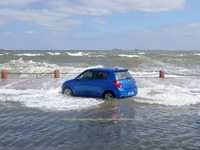 Big waves hit vehicles on Binhai North Road in Yantai, Shandong province, China, on September 21, 2024. (