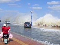 People take photos of waves on Binhai North Road in Yantai, China, on September 21, 2024. (