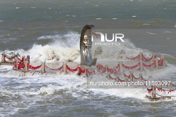 The base of the statue of the Old Man of the Moon is submerged by the tide at the Moon Bay scenic spot in Yantai, China, on September 21, 20...