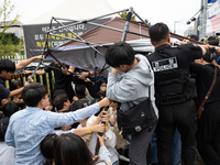 Police forcibly dismantle tents set up for a sit-in protest by around 50 members of the Progressive Union of Korean University Students in f...