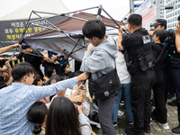 Police forcibly dismantle tents set up for a sit-in protest by around 50 members of the Progressive Union of Korean University Students in f...