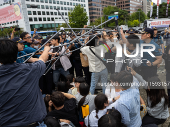 Police forcibly dismantle tents set up for a sit-in protest by around 50 members of the Progressive Union of Korean University Students in f...