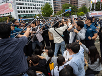 Police forcibly dismantle tents set up for a sit-in protest by around 50 members of the Progressive Union of Korean University Students in f...