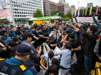 Police forcibly dismantle tents set up for a sit-in protest by around 50 members of the Progressive Union of Korean University Students in f...