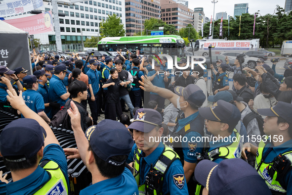 Police forcibly dismantle tents set up for a sit-in protest by around 50 members of the Progressive Union of Korean University Students in f...