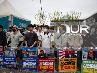 Around 50 members of the Progressive Union of Korean University Students stage a surprise sit-in protest in front of the National Assembly i...