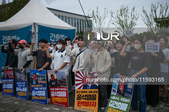 Around 50 members of the Progressive Union of Korean University Students stage a surprise sit-in protest in front of the National Assembly i...