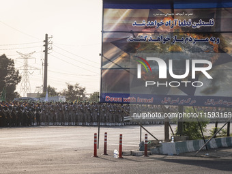 Islamic Revolutionary Guard Corps (IRGC) military personnel march next to an anti-Israeli banner in a military parade commemorating the anni...