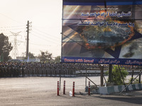 Islamic Revolutionary Guard Corps (IRGC) military personnel march next to an anti-Israeli banner in a military parade commemorating the anni...