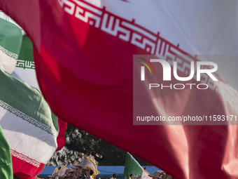 Islamic Revolutionary Guard Corps (IRGC) military personnel march under Iranian flags in a military parade commemorating the anniversary of...