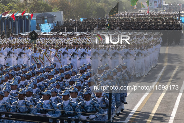 Iranian armed military personnel march in a military parade commemorating the anniversary of the Iran-Iraq War (1980-88) outside the Khomein...