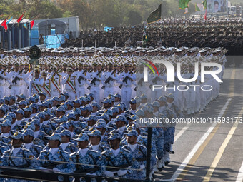 Iranian armed military personnel march in a military parade commemorating the anniversary of the Iran-Iraq War (1980-88) outside the Khomein...