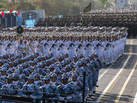 Iranian armed military personnel march in a military parade commemorating the anniversary of the Iran-Iraq War (1980-88) outside the Khomein...