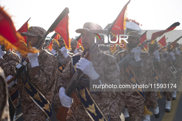 Islamic Revolutionary Guard Corps (IRGC) military personnel march in a military parade commemorating the anniversary of the Iran-Iraq War (1...