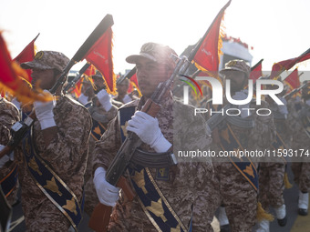 Islamic Revolutionary Guard Corps (IRGC) military personnel march in a military parade commemorating the anniversary of the Iran-Iraq War (1...