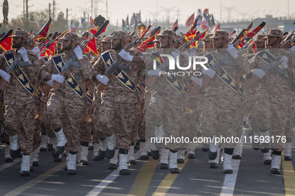 Armed Islamic Revolutionary Guard Corps (IRGC) military personnel march in a military parade commemorating the anniversary of the Iran-Iraq...