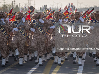 Armed Islamic Revolutionary Guard Corps (IRGC) military personnel march in a military parade commemorating the anniversary of the Iran-Iraq...