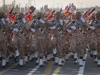 Armed Islamic Revolutionary Guard Corps (IRGC) military personnel march in a military parade commemorating the anniversary of the Iran-Iraq...