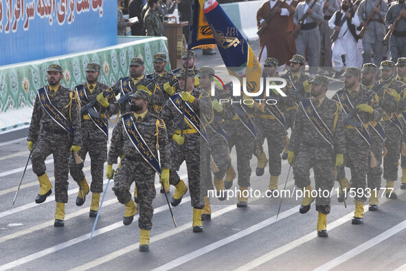 Armed Islamic Revolutionary Guard Corps (IRGC) military personnel march in a military parade commemorating the anniversary of the Iran-Iraq...