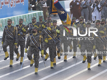 Armed Islamic Revolutionary Guard Corps (IRGC) military personnel march in a military parade commemorating the anniversary of the Iran-Iraq...