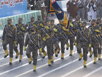 Armed Islamic Revolutionary Guard Corps (IRGC) military personnel march in a military parade commemorating the anniversary of the Iran-Iraq...