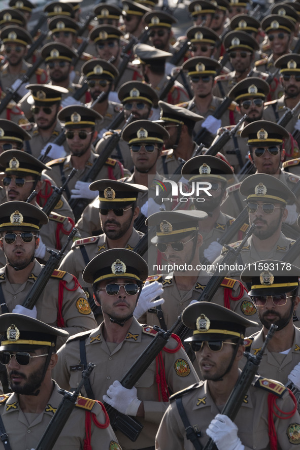 Members of the Iranian Army's land force march in a military parade commemorating the anniversary of the Iran-Iraq War (1980-88) outside the...