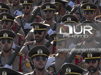 Members of the Iranian Army's land force march in a military parade commemorating the anniversary of the Iran-Iraq War (1980-88) outside the...